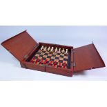 Early 20th century mahogany cased travelling chess set with bone red and white pieces, L25cm x W49.