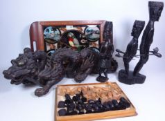 Two carved hardwood tribal figures, a similar chess set,