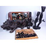 Two carved hardwood tribal figures, a similar chess set,