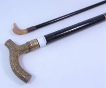 Vintage ebonised walking stick with brass handle and walking cane with bird moulded handle (2)