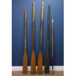 Pair of vintage rowing oars, two other oars and a boat hook,