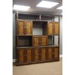 Late 20th century oriental hardwood large wall unit, combination cupboards enclosed by carved doors,