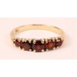 Gold five stone graduating garnet ring stamped 9ct Condition Report <a