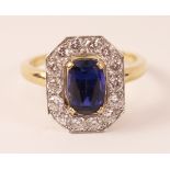 Sapphire and 14 stone diamond gold cluster ring with a central emerald cut sapphire tested to 18ct