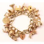 Gold curb chain charm bracelet hallmarked 9ct with 17 charms all hallmarked 9ct approx 68gm