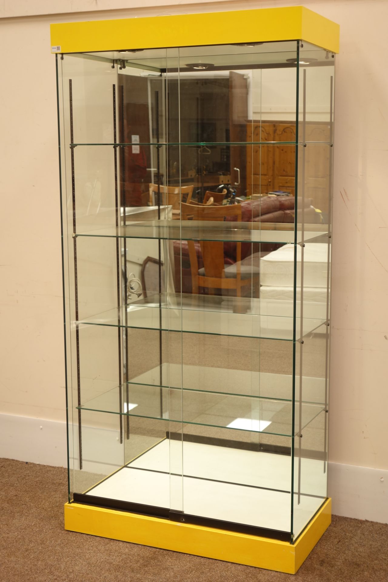 Glazed floor standing shop display cabinet with mirrored back and illuminated interior,