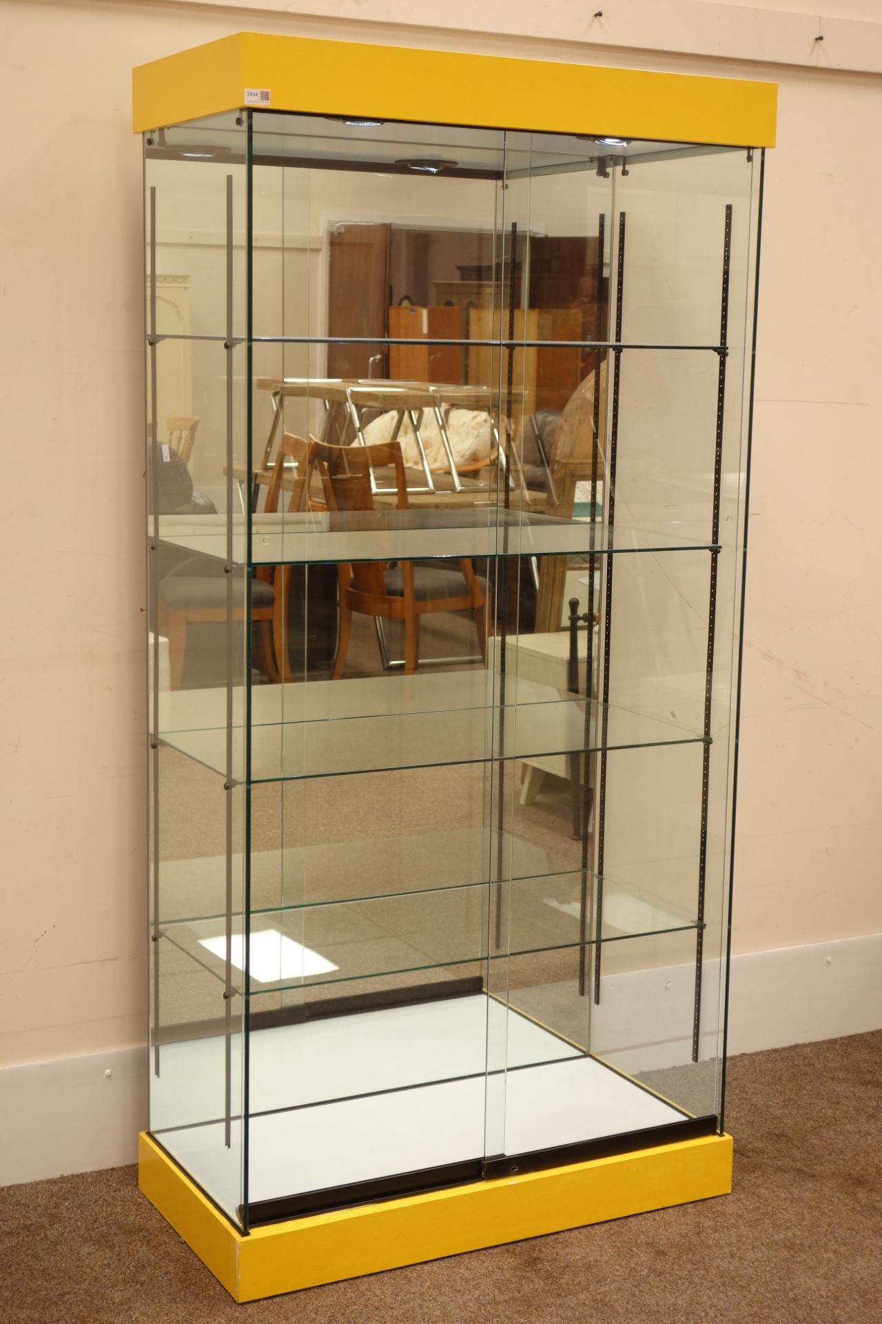 Glazed floor standing shop display cabinet with mirrored back and illuminated interior,