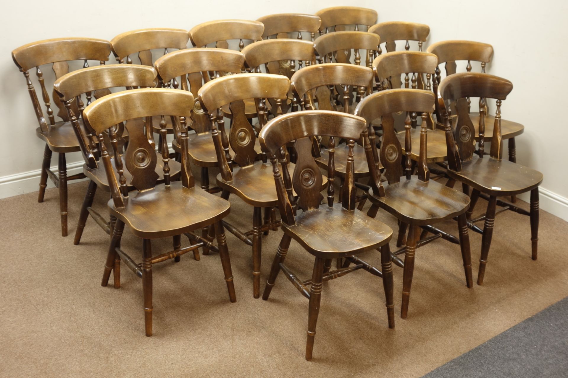 Set eighteen stained beech farmhouse style dining chairs, shaped splat back,