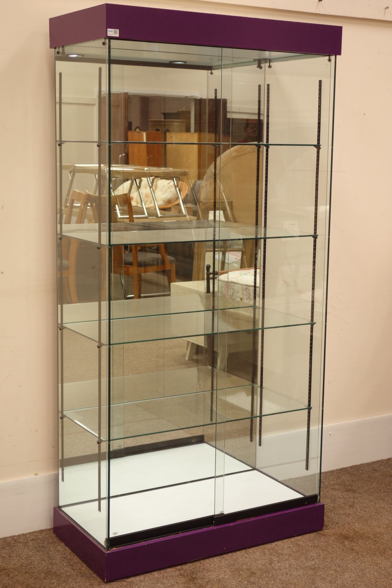 Glazed floor standing shop display cabinet with mirrored back and illuminated interior,