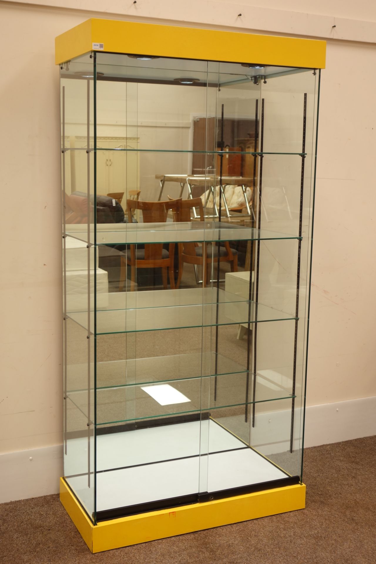 Glazed floor standing shop display cabinet with mirrored back and illuminated interior,