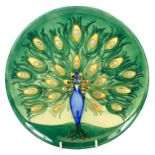 Moorcroft limited edition plate, decorated with a peacock on green ground, dated 1994, 117/500,