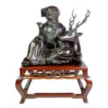 Japanese Meiji period bronze model of a seated Jurojin with deer, on hardwood square stand,