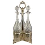 Late Victorian pierced silver-plated decanter stand with three cut crystal decanters,