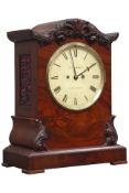 Victorian mahogany mantel clock, serpentine pediment with carved floral mounts,