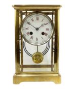 Late 19th century brass and bevel glazed mantel clock, white enamel dial with Roman numerals,
