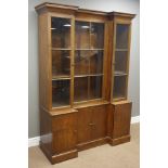 Early 20th century oak reverse break front bookcase, three astragal glazed doors above cupboards,