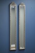Pair narrow bevelled edge wall mirrors in silvered frame with ornate pediments,