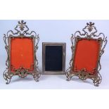 Pair of Art Nouveau easel picture frames with pierced brass scrolling borders,