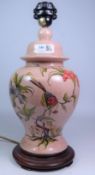 French pottery table lamp, with flower and exotic bird decoration on crazed pink grounds,