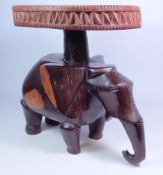 Tribal hardwood stool with circular carved top on elephant base,