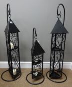 Pair of black finish lanterns on stand, H100cm and a smaller matching lantern on stand,