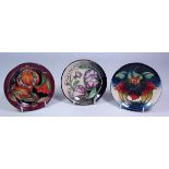 Three Moorcroft circular pin dishes, 'Anna Lily' 1998 and two others dated 2003,