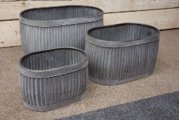 Three galvanized metal oval graduating dolly tub type planters,