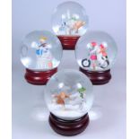 Four Coalport The Snowman snow globes; 'Hold On Tight', 'The Adventure Begins',