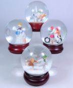 Four Coalport The Snowman snow globes; 'Hold On Tight', 'The Adventure Begins',