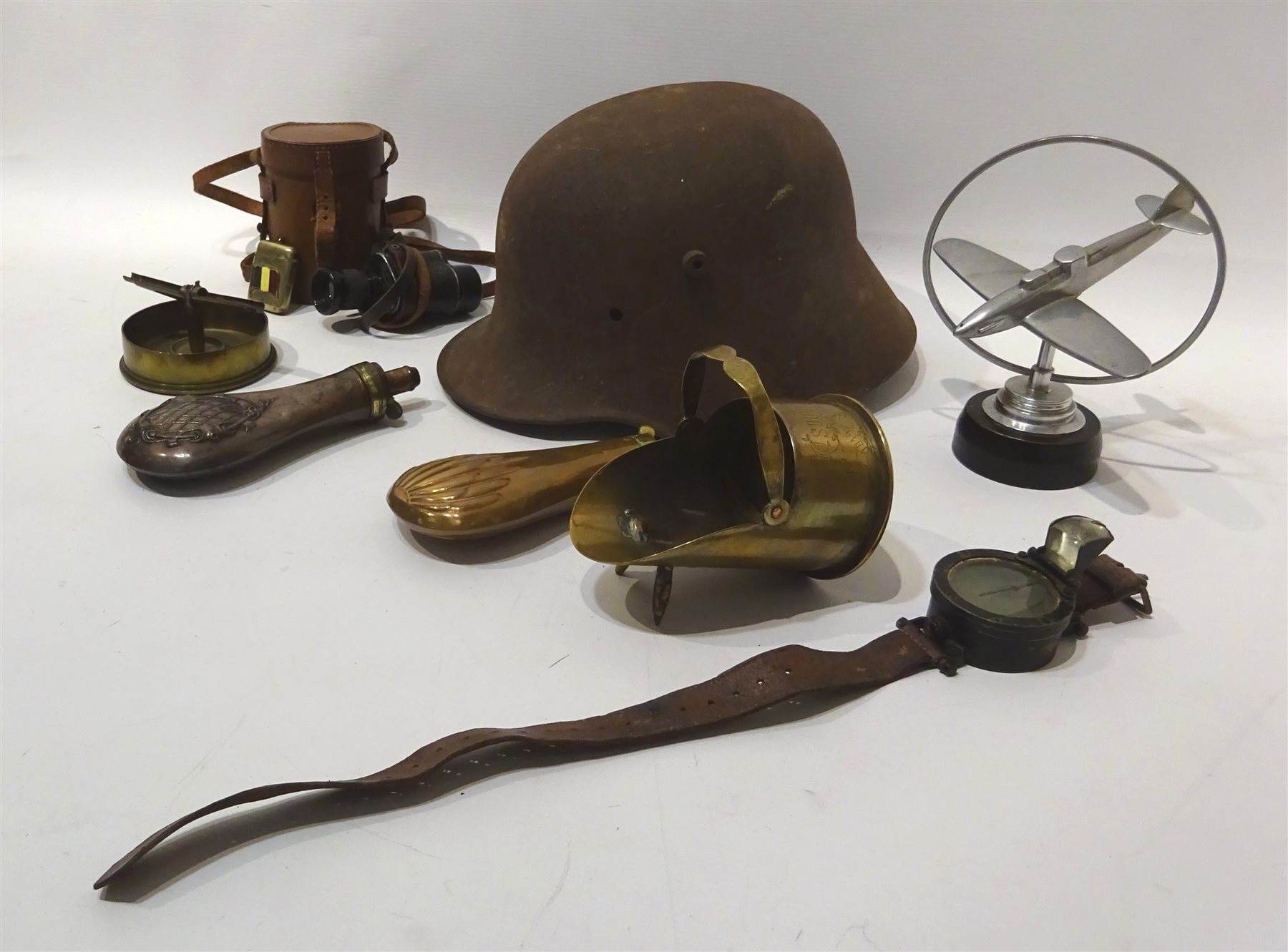 WWl German steel helmet, Trench Art brass sugar helmet 'Souvenir from Sailly' similar ashtray,