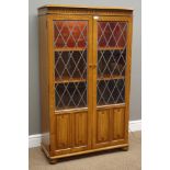Medium oak bookcase enclosed by lead glazed and linen fold panelled doors, W80cm, H131cm,