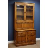 'Ercol' golden dawn finish elm wall unit, raised display cabinets above fall front,