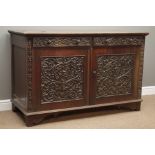 Early 20th century oak sideboard, two drawers above panelled cupboards with applied carvings,