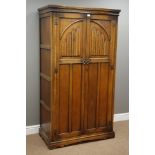 Medium oak carved linen fold double wardrobe, interior fitted with mirror,