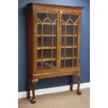 Victorian figured mahogany bookcase enclosed by two astragal glazed doors on later stand with ball
