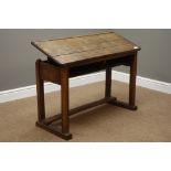Early 20th century child's school desk with hinged adjustable top, W103cm, H62cm,