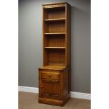 Narrow 'Ercol' golden dawn finish elm bookcase on cupboard with drawer, W52cm, H197cm,