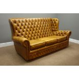 Wingback Chesterfield type three seat settee upholstered in tan leather,