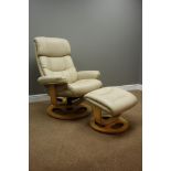 Reclining swivel armchair upholstered in cream fabric and matching footstool - six months old