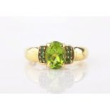Gold single stone peridot and emerald ring hallmarked 9ct Condition Report <a