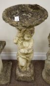 Stone effect garden bird bath, cherub holding shallow bath on plinth,