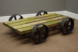 Wood slatted cart with four wrought metal wheels,
