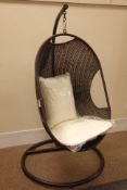 Black finish metal framed hanging rattan egg chair with upholstered loose cushions,