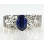 Openwork white gold ring set with single sapphire and diamond leaves stamped 18k with additional