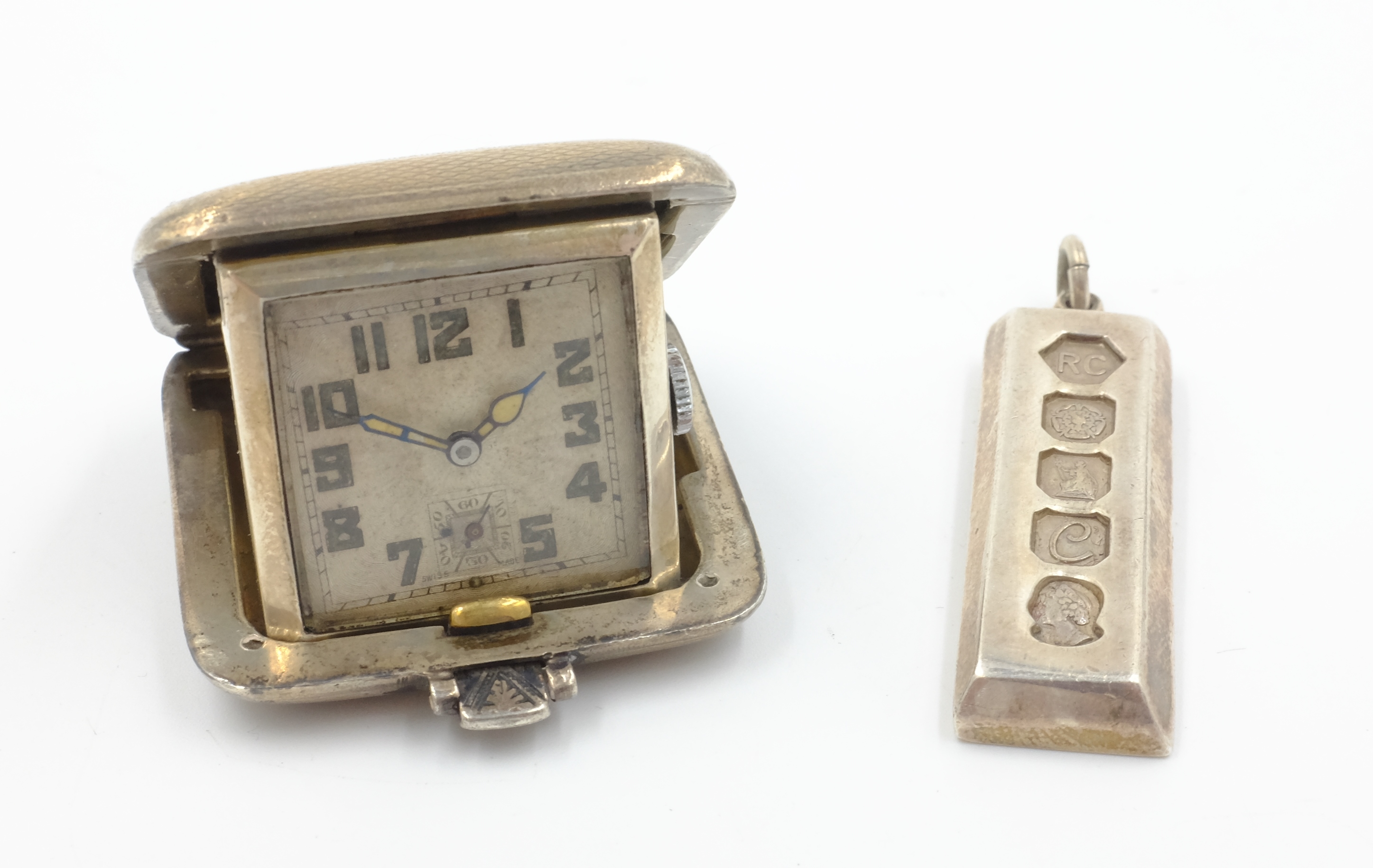 Art Deco silver cased travel clock by SSM Birmingham 1932 4cm square and 1977 Silver Jubilee ingot