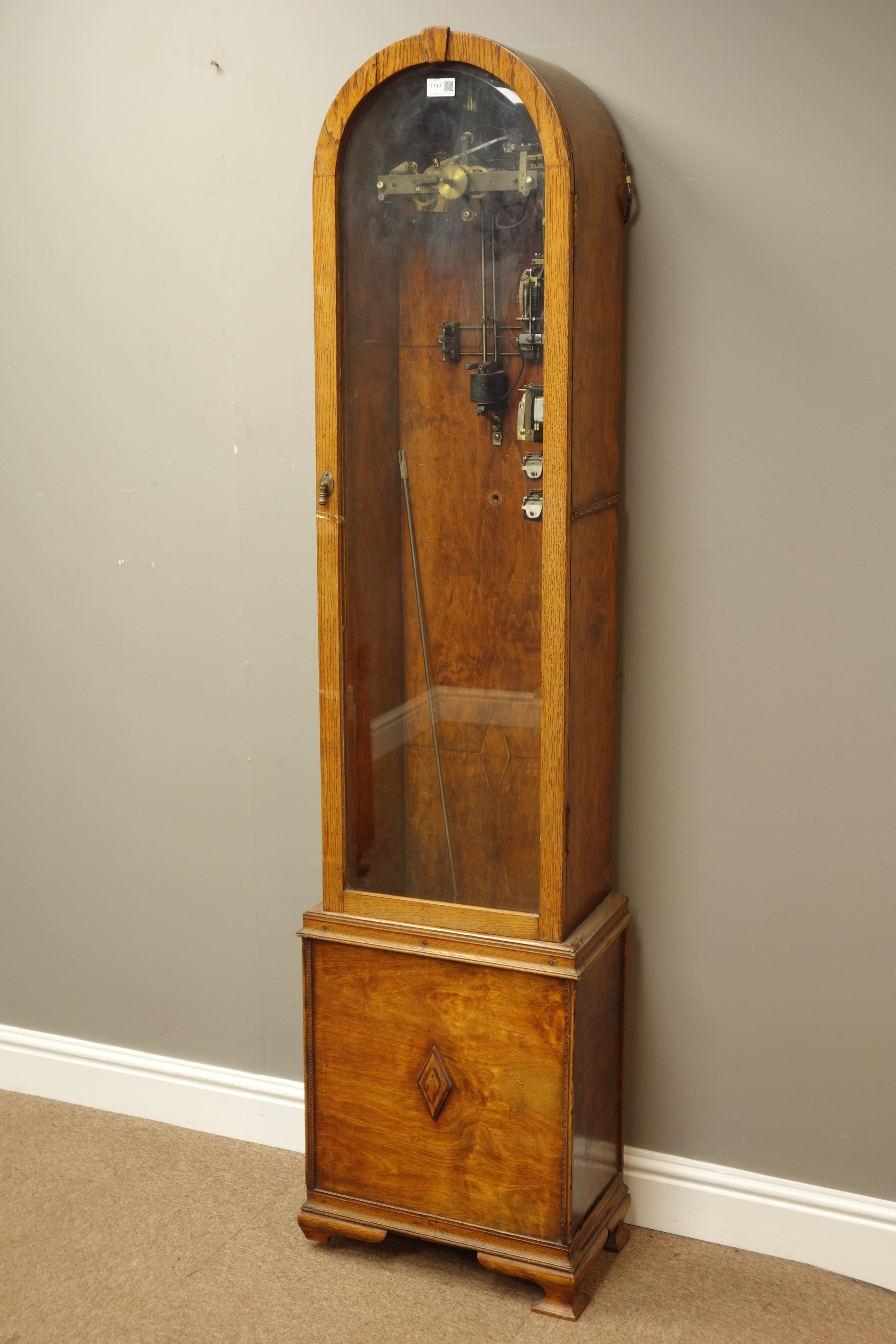20th century electric clock, arched top with glazed door on bracket feet, with pendulum,