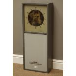 STR electric wall clock, square Arabic dial with visible brass movement in grey painted case,