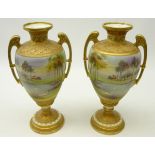 Pair Nippon type urn shaped vases, hand painted with a lake scene, gilded arms and borders,