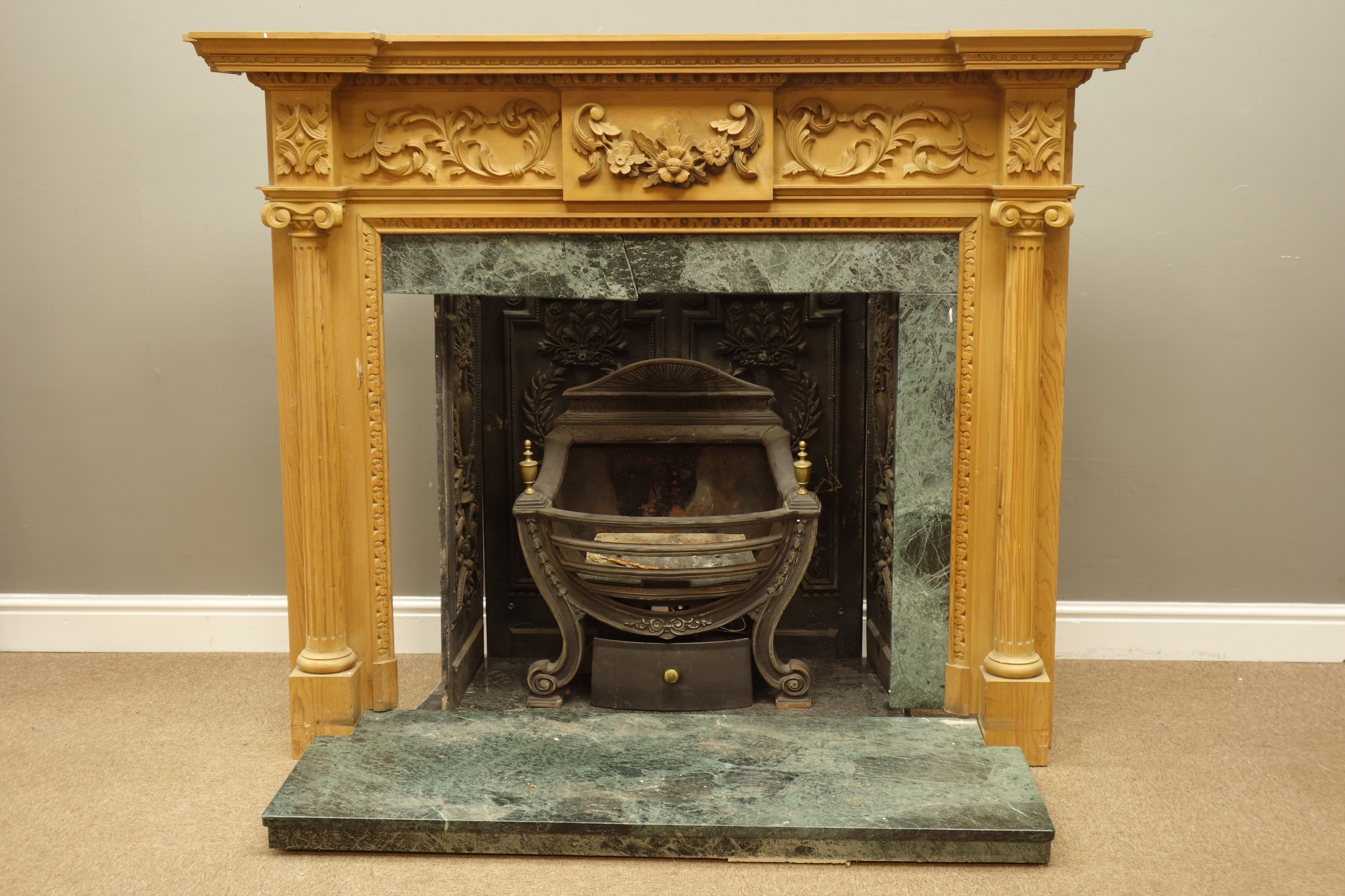 Adams style carved pine fireplace surround with carved floral and acanthus leaf mounts,