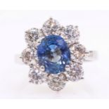 White gold oval sapphire and round brilliant cut diamond cluster ring hallmarked 18ct sapphire